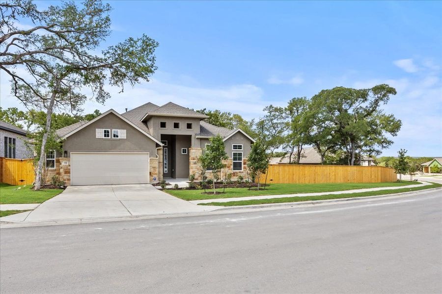 Front exterior of a new home in 6 Creeks, Kyle, TX, highlighting curb appeal (Image 19). Front exterior of a new home in 6 Creeks, Kyle, TX, highlighting curb appeal (Image 19).
