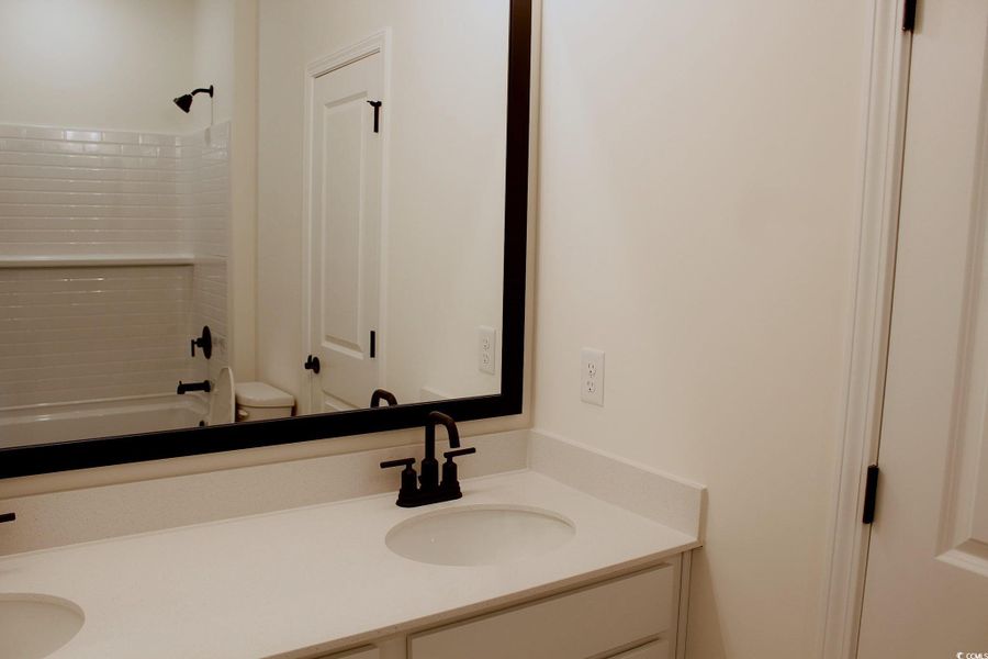 Bathroom featuring double vanity and shower / washtub combination Bathroom featuring double vanity and shower / washtub combination