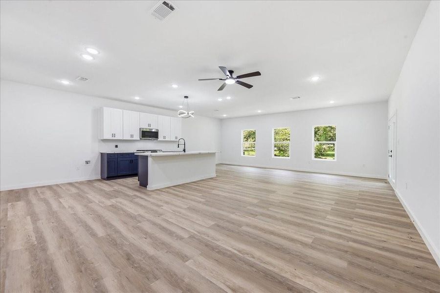 Expansive open-concept living area seamlessly connecting the kitchen, dining, and family room. Expansive open-concept living area seamlessly connecting the kitchen, dining, and family room.