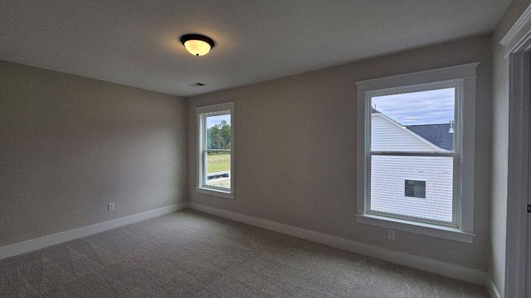 Spacious, unfurnished interior of a new home in The Enclave at French Quarter Creek, Huger (Image 17).