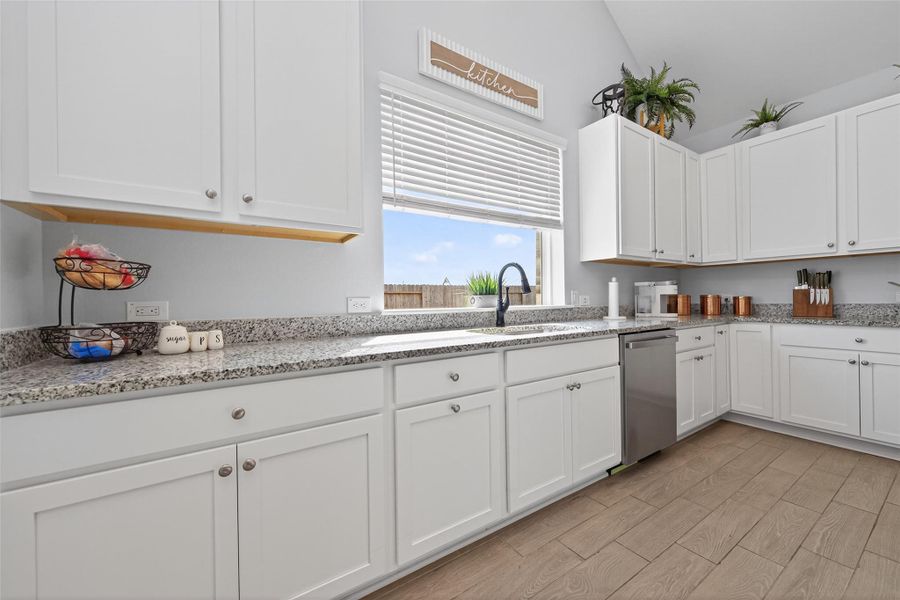 Bright kitchen area with ample cabinetry and convenient workspace