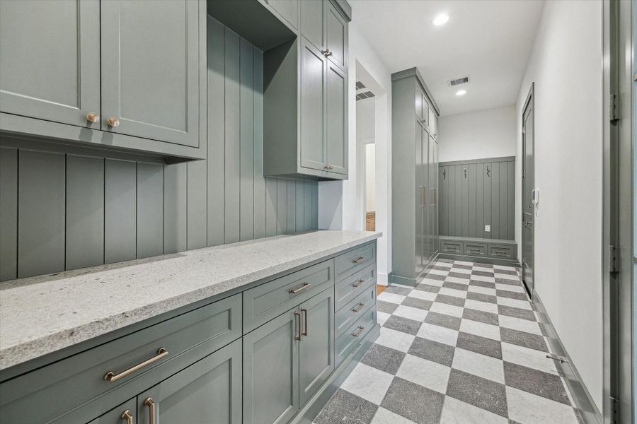 Another view of expansive built ins in MUD room with lockers, bench seating, hooks, and doors to both garage and portico! Another view of expansive built ins in MUD room with lockers, bench seating, hooks, and doors to both garage and portico!
