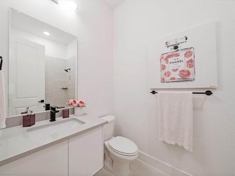 Full bath featuring vanity, tiled shower, and light tile patterned floors Full bath featuring vanity, tiled shower, and light tile patterned floors