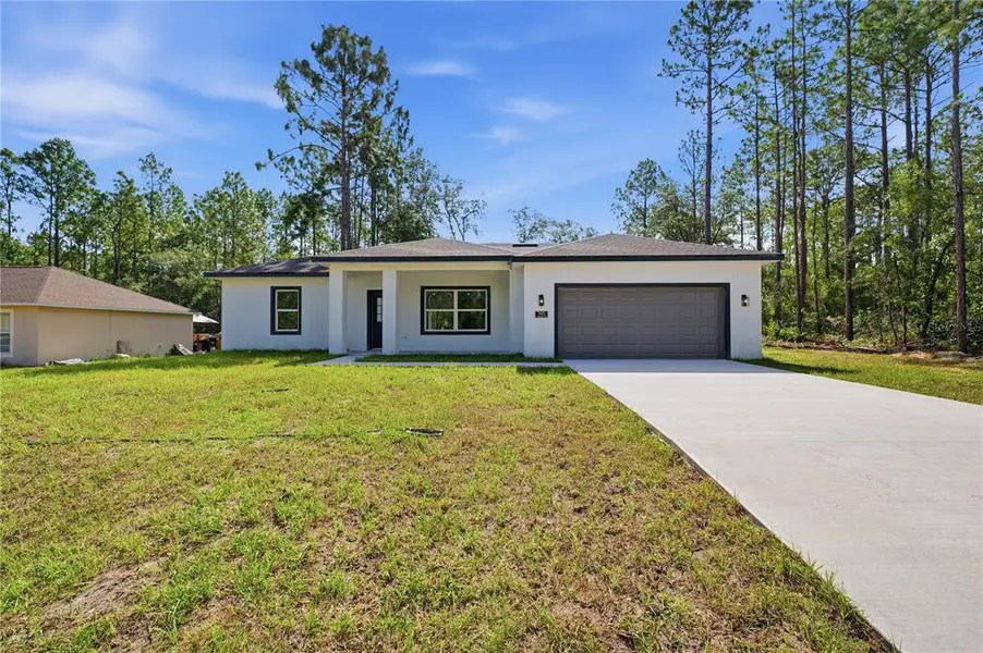 Front exterior of a new home in , Citrus Springs, FL, highlighting curb appeal (Image 1). Front exterior of a new home in , Citrus Springs, FL, highlighting curb appeal (Image 1).