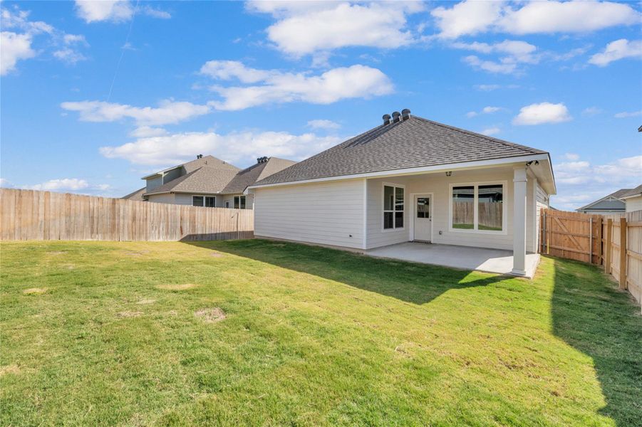 Back of house featuring a fenced backyard, a patio, and a shingled roof Back of house featuring a fenced backyard, a patio, and a shingled roof