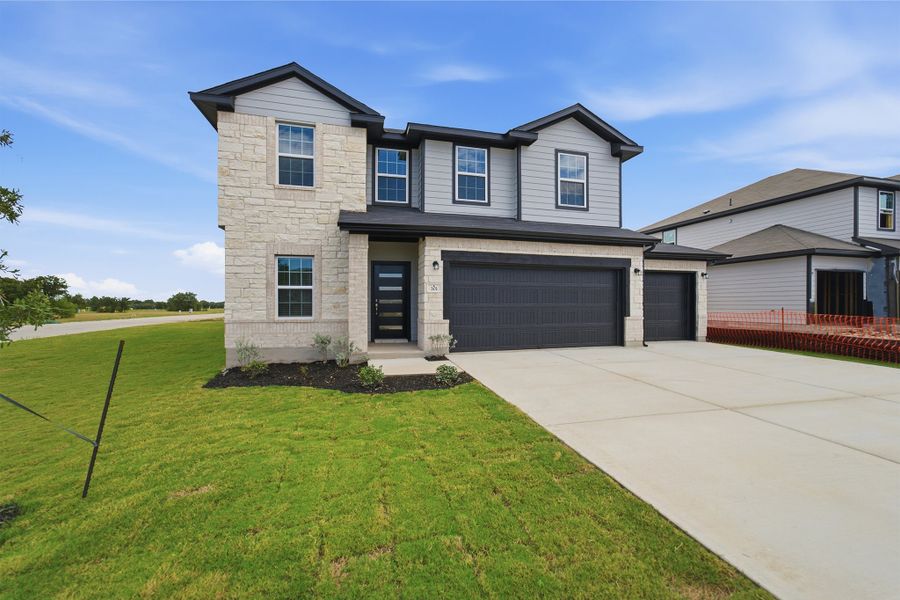 Front exterior of a new home in Grande Estates, Bertram, TX, highlighting curb appeal (Image 2). Front exterior of a new home in Grande Estates, Bertram, TX, highlighting curb appeal (Image 2).