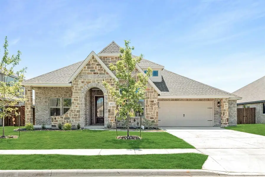 Stone and brick exterior with an arched entryway Stone and brick exterior with an arched entryway