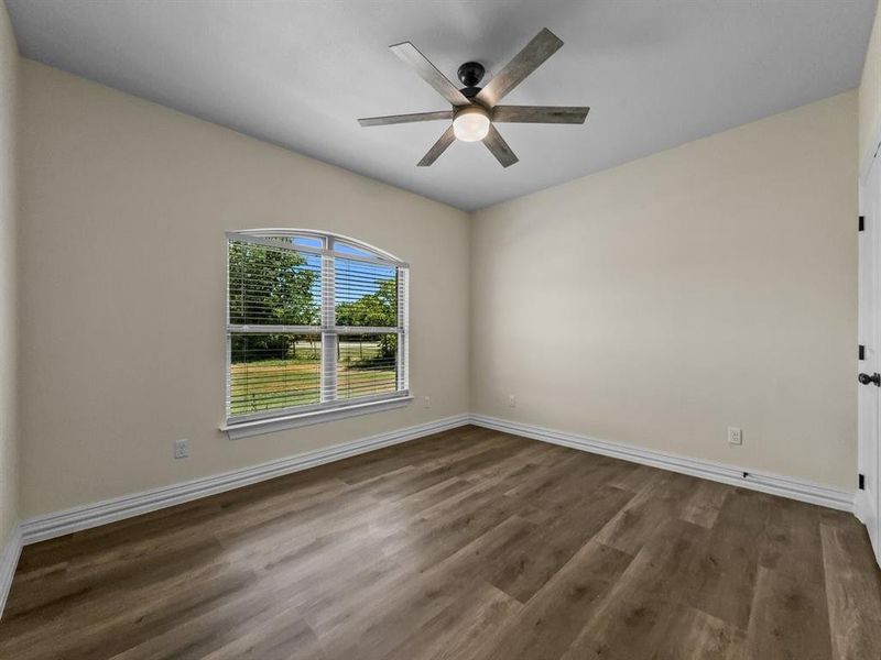 Empty room featuring ceiling fan and wood finished floors Empty room featuring ceiling fan and wood finished floors