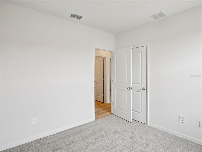 Spacious, unfurnished interior of a new home in The Grove at Stuart Crossing - Premier Series, Bartow (Image 15).