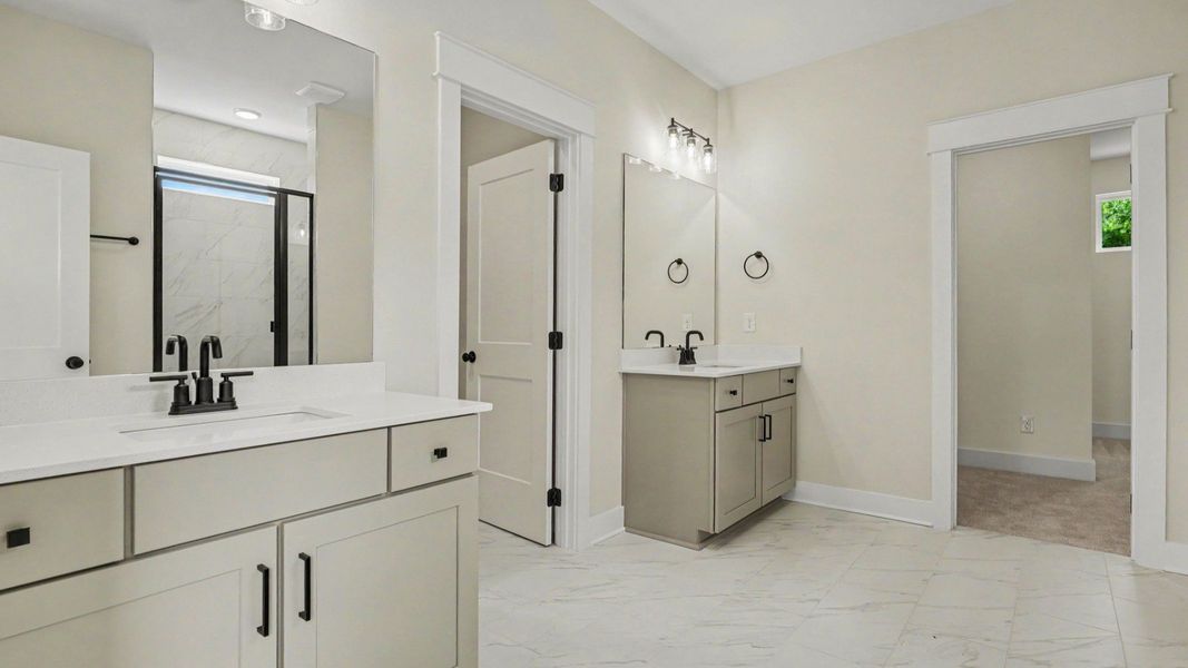 Primary bathroom with dual vanity, glass enclosed shower, and closet Primary bathroom with dual vanity, glass enclosed shower, and closet