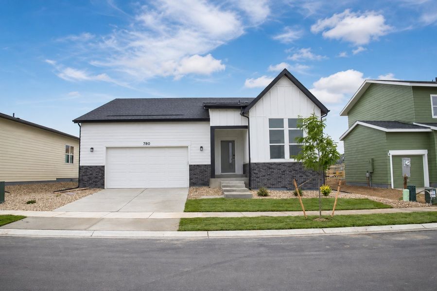 Front exterior of a new home in Prairie Song, Windsor, CO, highlighting curb appeal (Image 2). Front exterior of a new home in Prairie Song, Windsor, CO, highlighting curb appeal (Image 2).