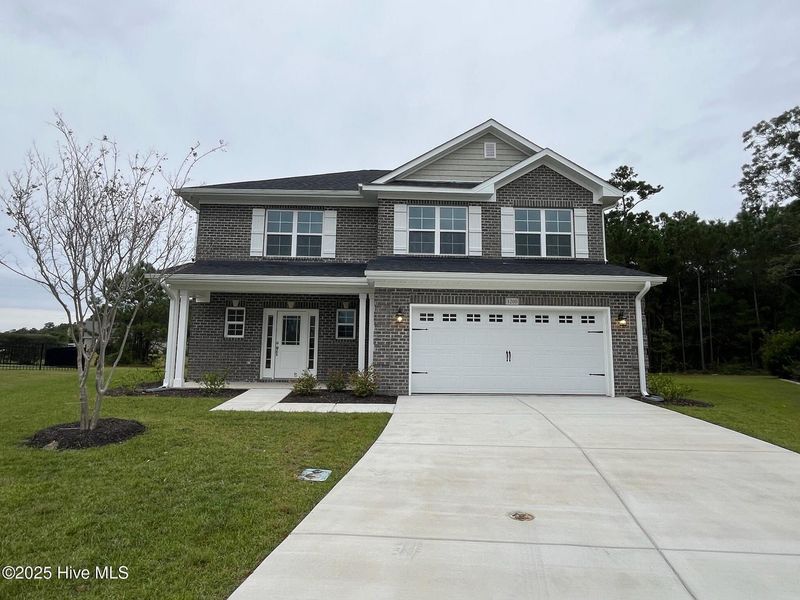 Front exterior of a new home in Palmetto Creek, Bolivia, NC, highlighting curb appeal (Image 1).