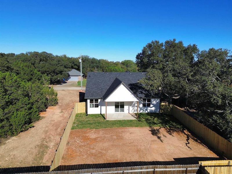 Rear view of house featuring a patio area and a lawn