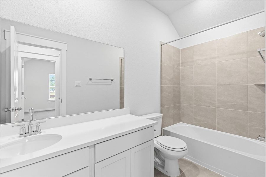 Full bath featuring vanity, shower / washtub combination, and light tile patterned floors