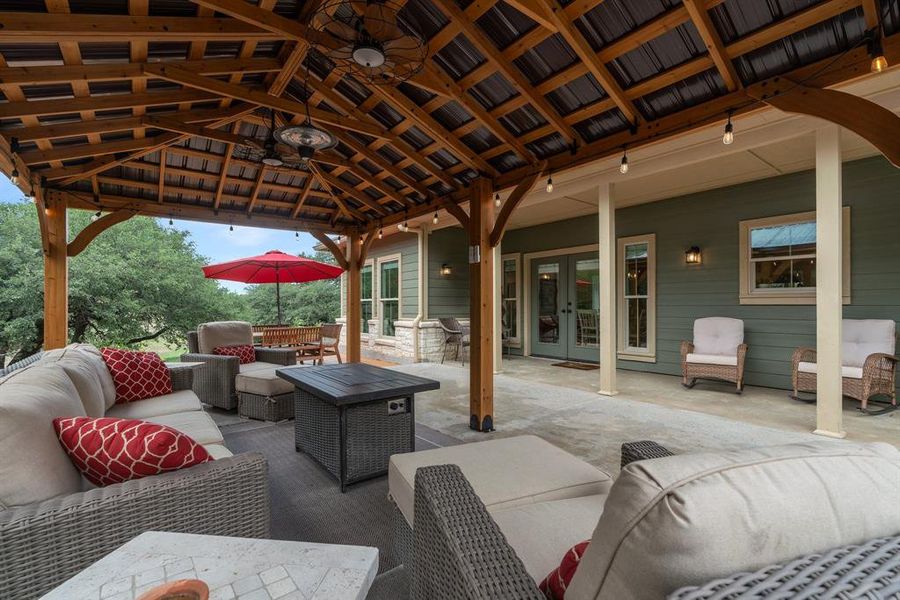 This large covered sitting area is located off the kitchen and dining space of home number one