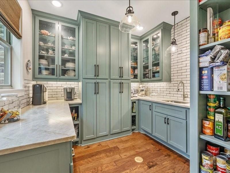10x10 Walk-in Pantry with so much storage you won't believe.  All custom cabinets with pull out drawers.  Sink and disposal.  Coffee bar that looks out to the pines.