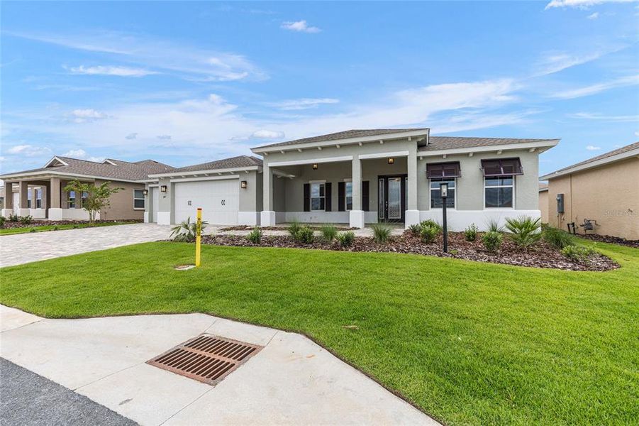 Front exterior of a new home in On Top of the World Communities, Ocala, FL, highlighting curb appeal (Image 17).