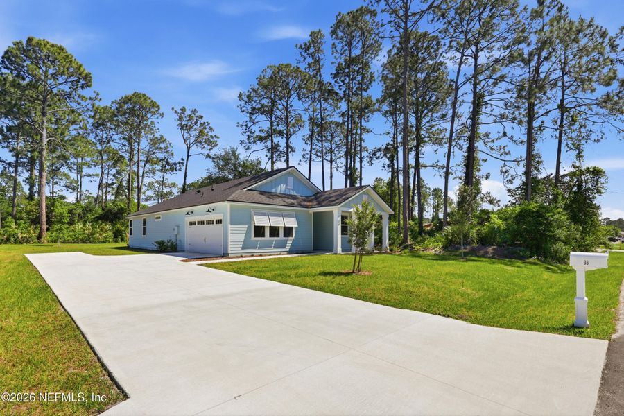 Front exterior of a new home in Palm Coast Homes, Palm Coast, FL, highlighting curb appeal (Image 27).