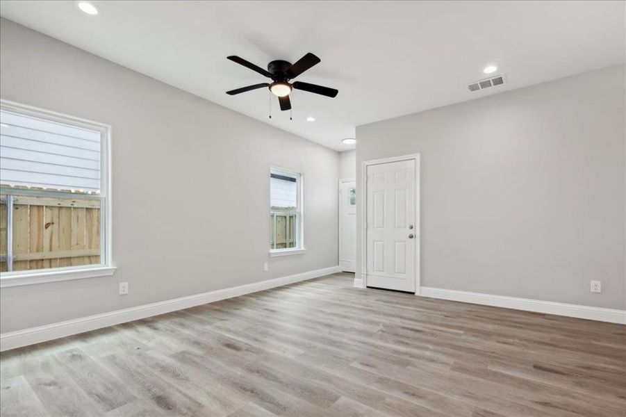 Spare room featuring wood-type flooring and ceiling fan