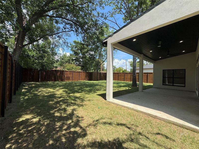 Fenced backyard featuring ceiling fan and a patio Fenced backyard featuring ceiling fan and a patio