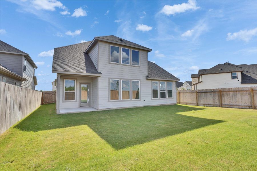 Back of house with roof with shingles, a patio area, and a fenced backyard Back of house with roof with shingles, a patio area, and a fenced backyard