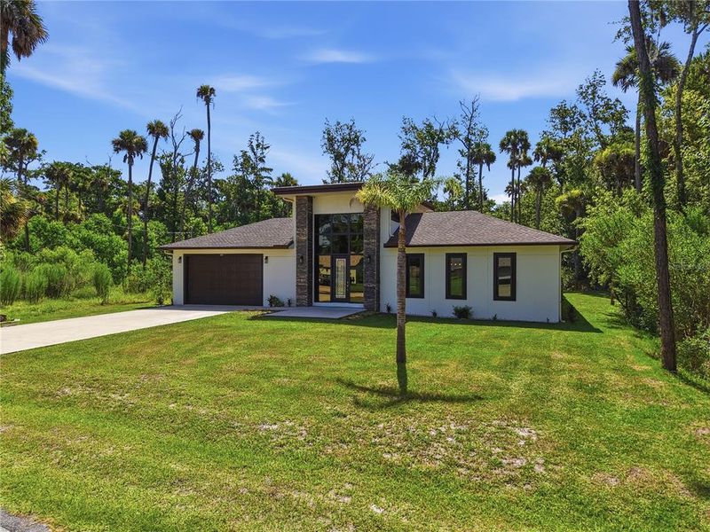Front exterior of a new home in , Palm Coast, FL, highlighting curb appeal (Image 24). Front exterior of a new home in , Palm Coast, FL, highlighting curb appeal (Image 24).