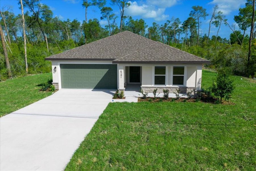 Front exterior of a new home in , Spring Hill, FL, highlighting curb appeal (Image 29). Front exterior of a new home in , Spring Hill, FL, highlighting curb appeal (Image 29).