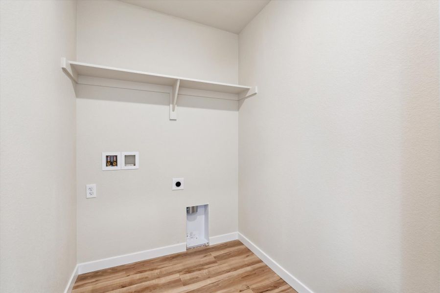 A white room with a wood floor and a wood floor.