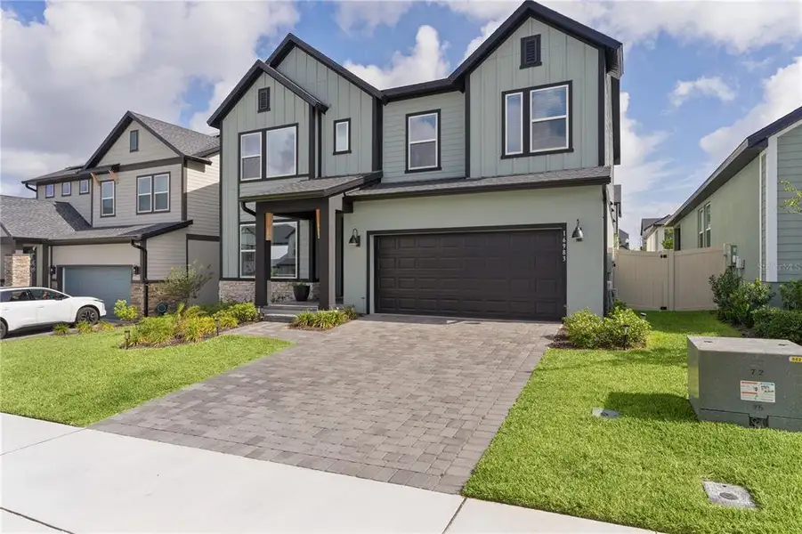 Front exterior of a new home in , Clermont, FL, highlighting curb appeal (Image 25).