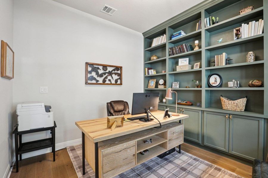 The main floor features a spacious home office with built-in cabinetry, perfect for remote work or study.