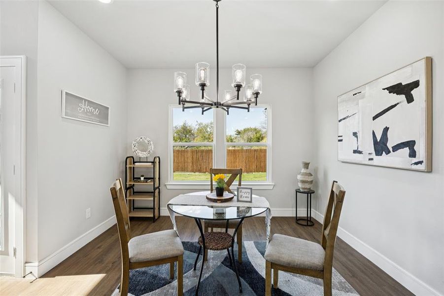Dining room with dark wood-style flooring, a chandelier, and recessed lighting