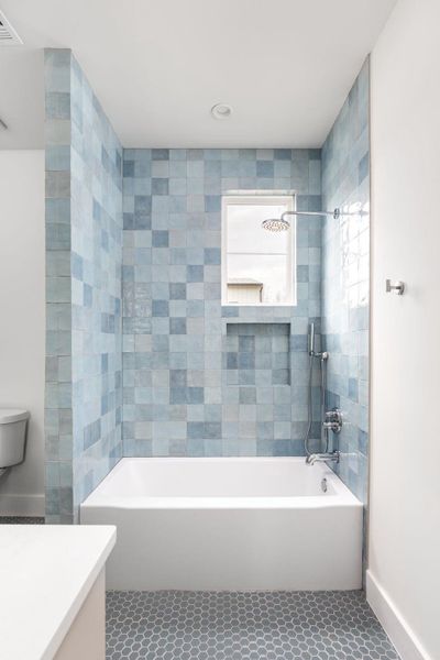 Bathroom featuring vanity, tile patterned floors, and bathing tub / shower combination