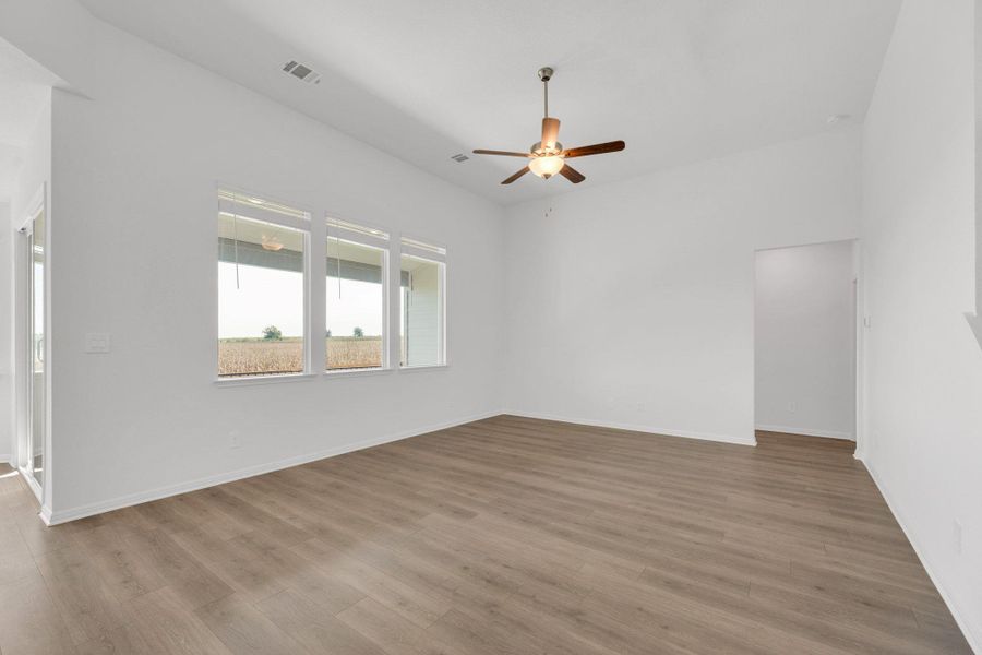 Spare room featuring light wood-style flooring and a ceiling fan Spare room featuring light wood-style flooring and a ceiling fan