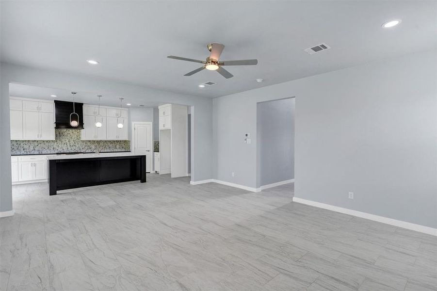Unfurnished living room with recessed lighting and a ceiling fan