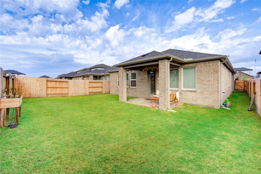 The expansive property features a generous green space that enhances the overall outdoor setting, offering ample room for recreation and future customization. This well-balanced landscape creates a natural and inviting environment, ideal for outdoor activities, relaxation, and personal enjoyment.