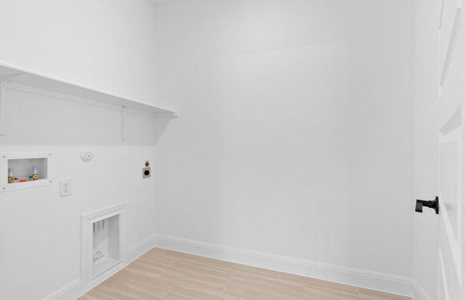 Laundry area with gas dryer hookup, hookup for a washing machine, and electric dryer hookup Laundry area with gas dryer hookup, hookup for a washing machine, and electric dryer hookup