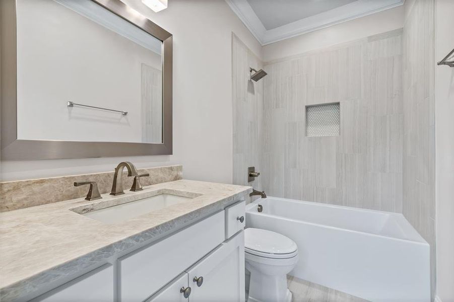 Bathroom with vanity, shower combination, and ornamental molding Bathroom with vanity, shower combination, and ornamental molding