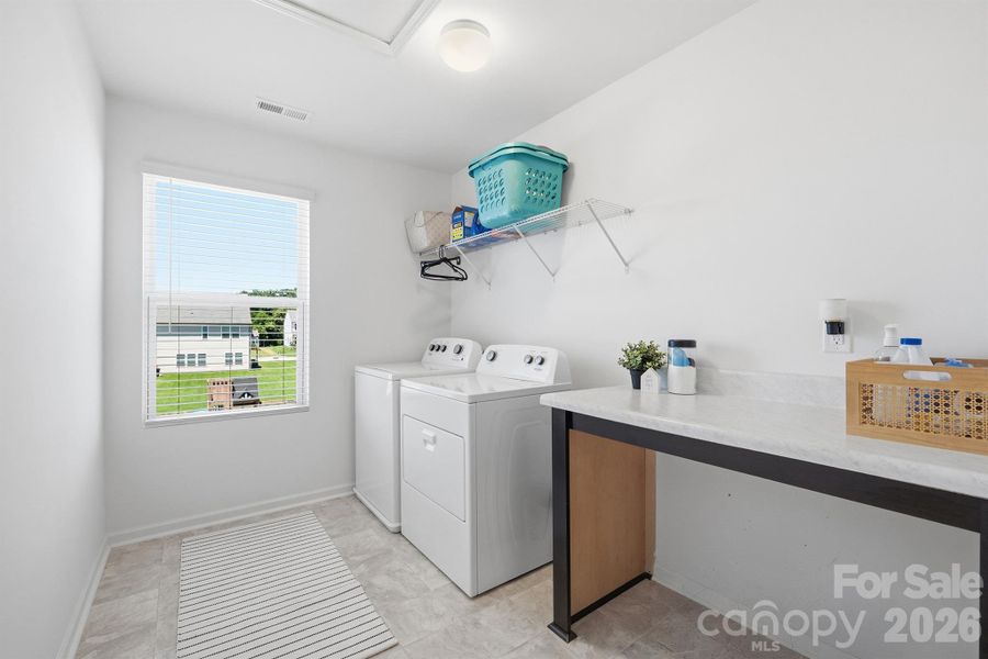 Oversized laundry room with folding table