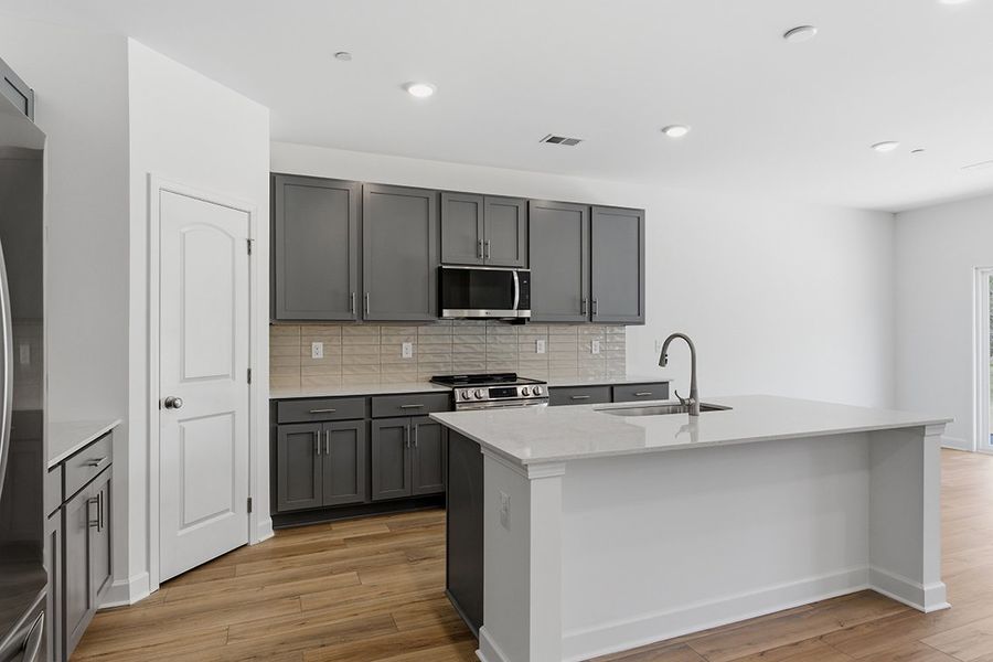 A kitchen with black cabinets. A kitchen with black cabinets.