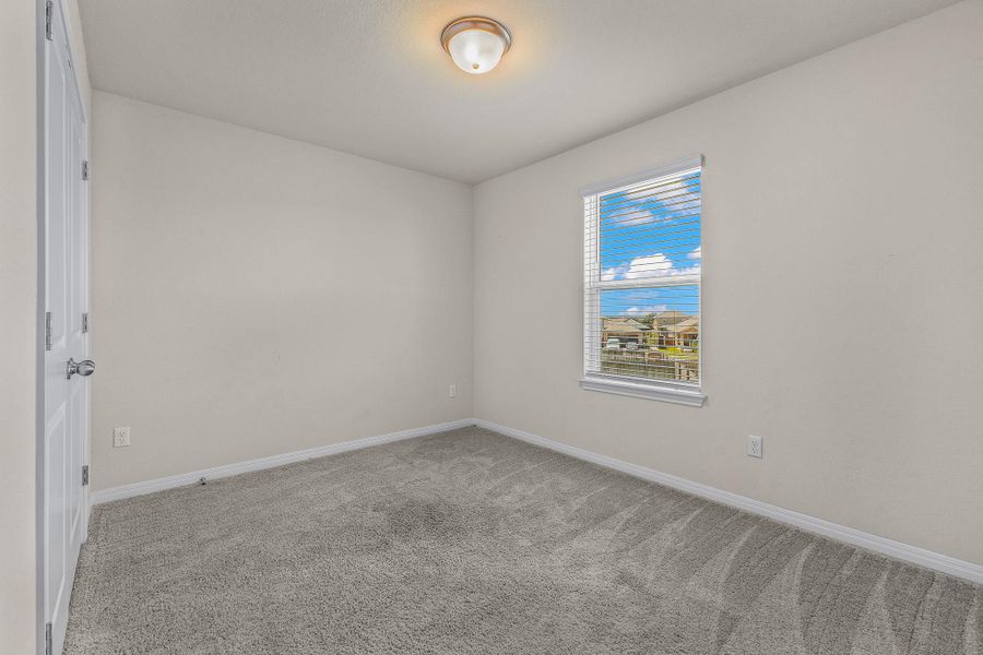 Spare room featuring light carpet and baseboards Spare room featuring light carpet and baseboards