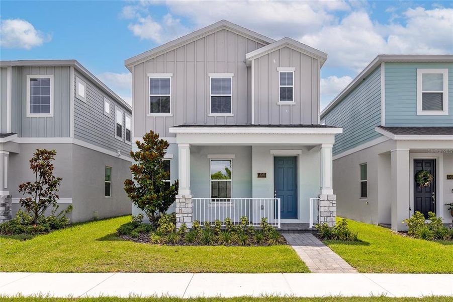 Front exterior of a new home in Serenade at Ovation, Winter Garden, FL, highlighting curb appeal (Image 21). Front exterior of a new home in Serenade at Ovation, Winter Garden, FL, highlighting curb appeal (Image 21).