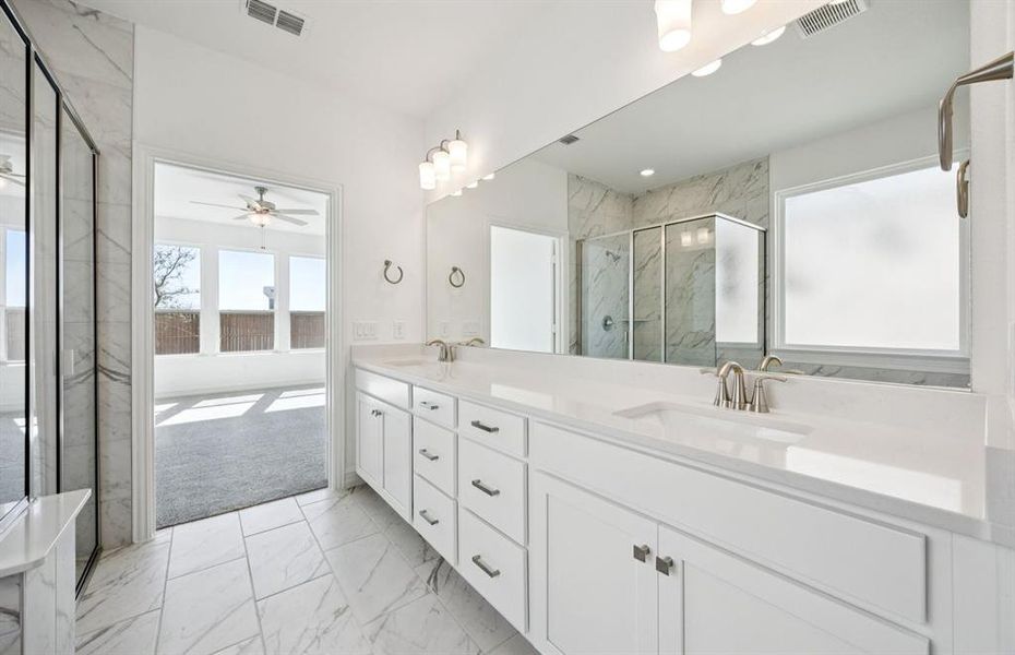 Owner's bathroom features double vanity and large shower