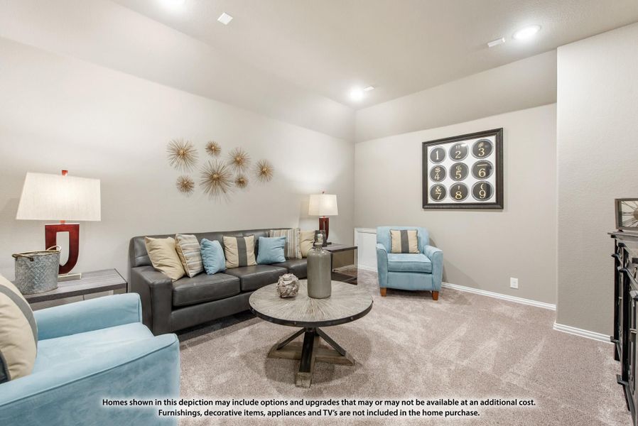 Living room with gray leather sofa, blue accent chairs, round wood coffee table, and carpet flooring Living room with gray leather sofa, blue accent chairs, round wood coffee table, and carpet flooring