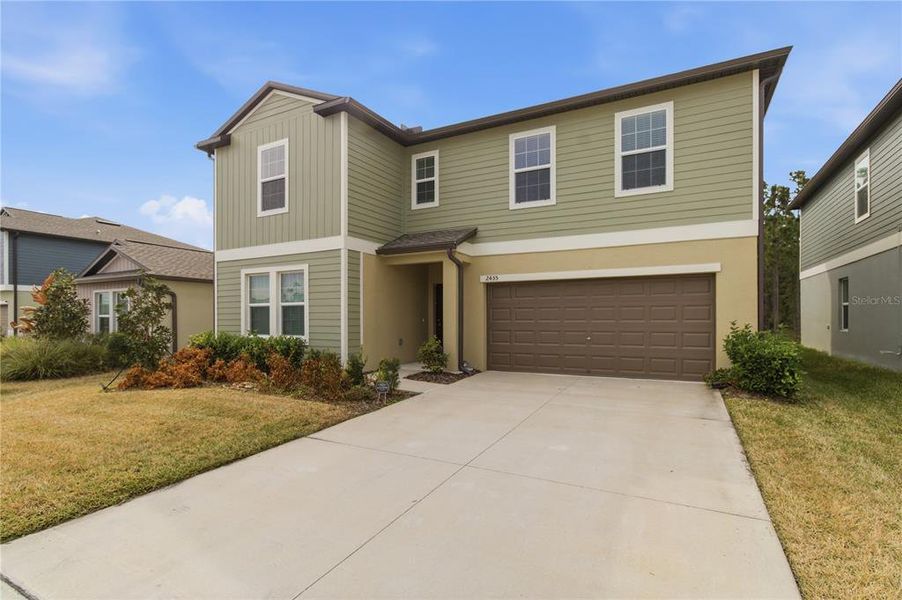 Front exterior of a new home in Two Rivers, Zephyrhills, FL, highlighting curb appeal (Image 2). Front exterior of a new home in Two Rivers, Zephyrhills, FL, highlighting curb appeal (Image 2).