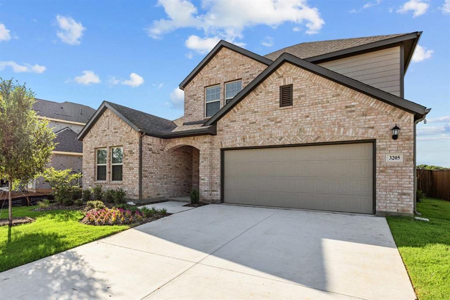 Front exterior of a new home in Kings Way, Denton, TX, highlighting curb appeal (Image 16). Front exterior of a new home in Kings Way, Denton, TX, highlighting curb appeal (Image 16).