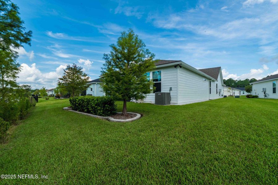 Front exterior of a new home in Summer Bay at Grand Oaks, St. Augustine, FL, highlighting curb appeal (Image 18). Front exterior of a new home in Summer Bay at Grand Oaks, St. Augustine, FL, highlighting curb appeal (Image 18).