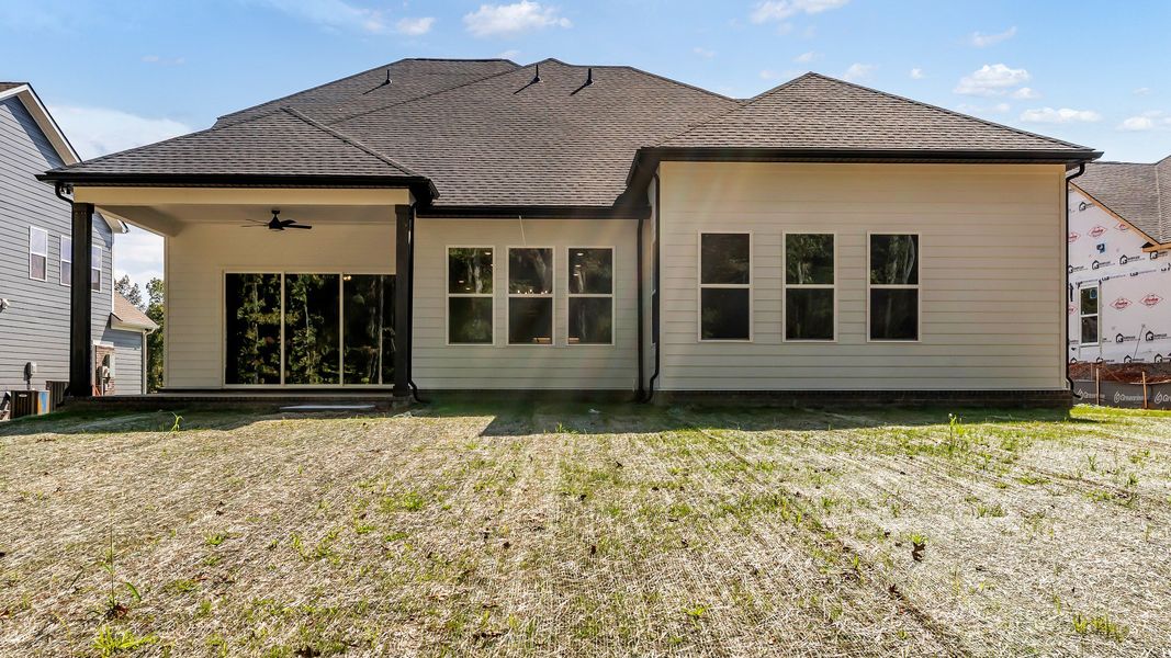 Exterior of home with covered rear porch (Representative of finished home)