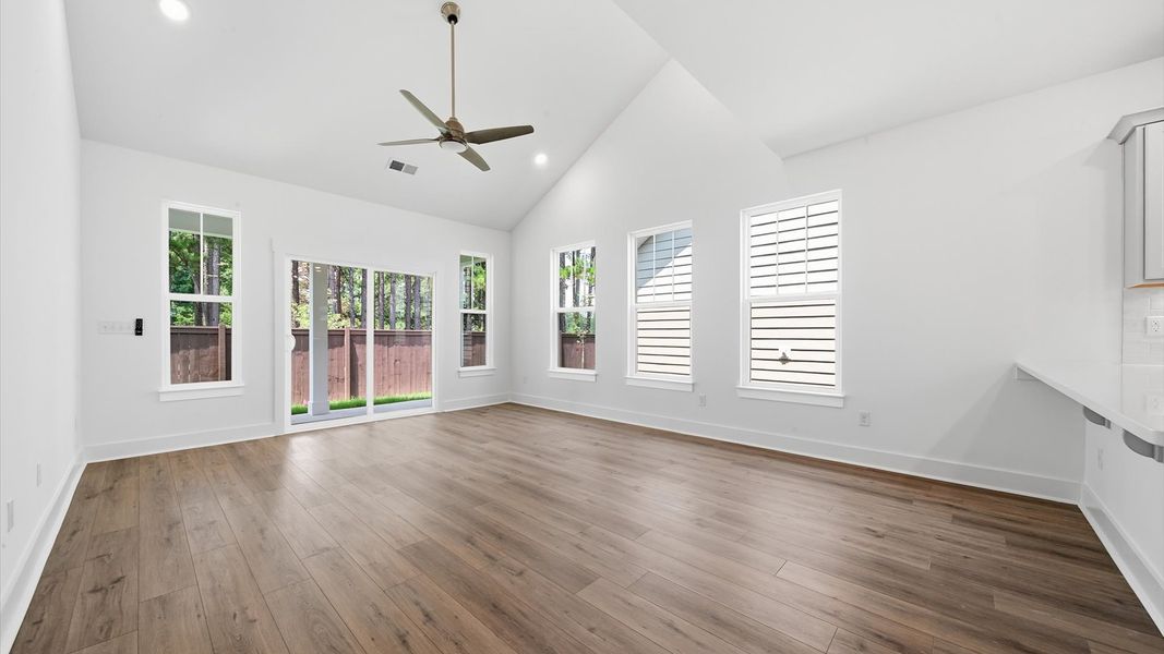 Tasteful family room with two-story volume, refined finishes, and exceptional natural light Tasteful family room with two-story volume, refined finishes, and exceptional natural light