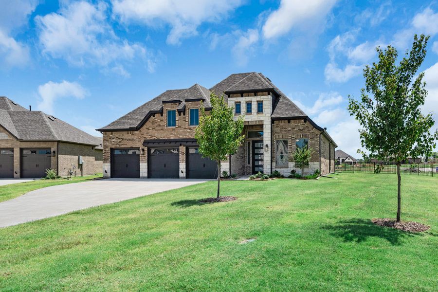 Front exterior of a new home in Heath Golf and Yacht Club, Heath, TX, highlighting curb appeal (Image 17). Front exterior of a new home in Heath Golf and Yacht Club, Heath, TX, highlighting curb appeal (Image 17).