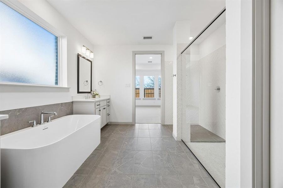 You'll enjoy a spa like experience every day in this spacious owner's bath with freestanding tub and walk in shower with optional drying area! You'll enjoy a spa like experience every day in this spacious owner's bath with freestanding tub and walk in shower with optional drying area!